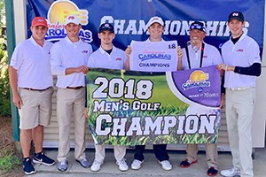 Golf Champs holding the 2018 Men's Golf Champions banner.